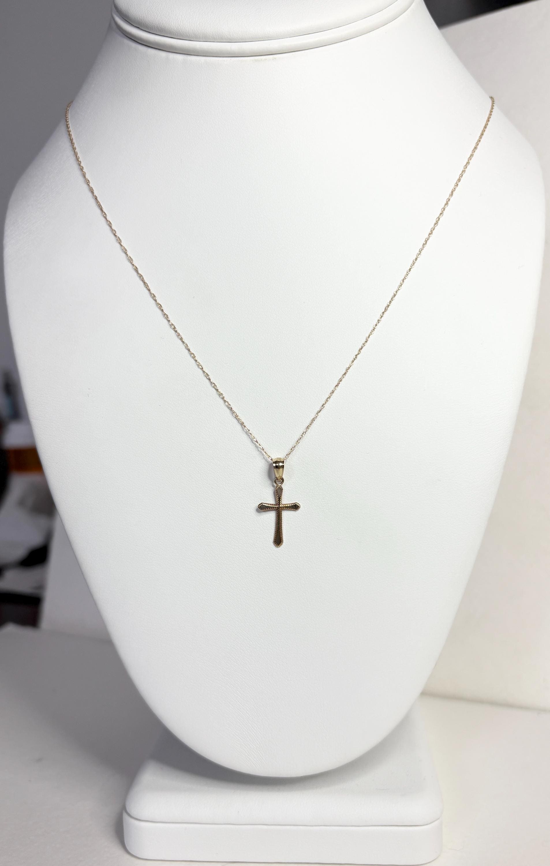 Solid 10k gold cross pendant on a 19-inch rope chain.