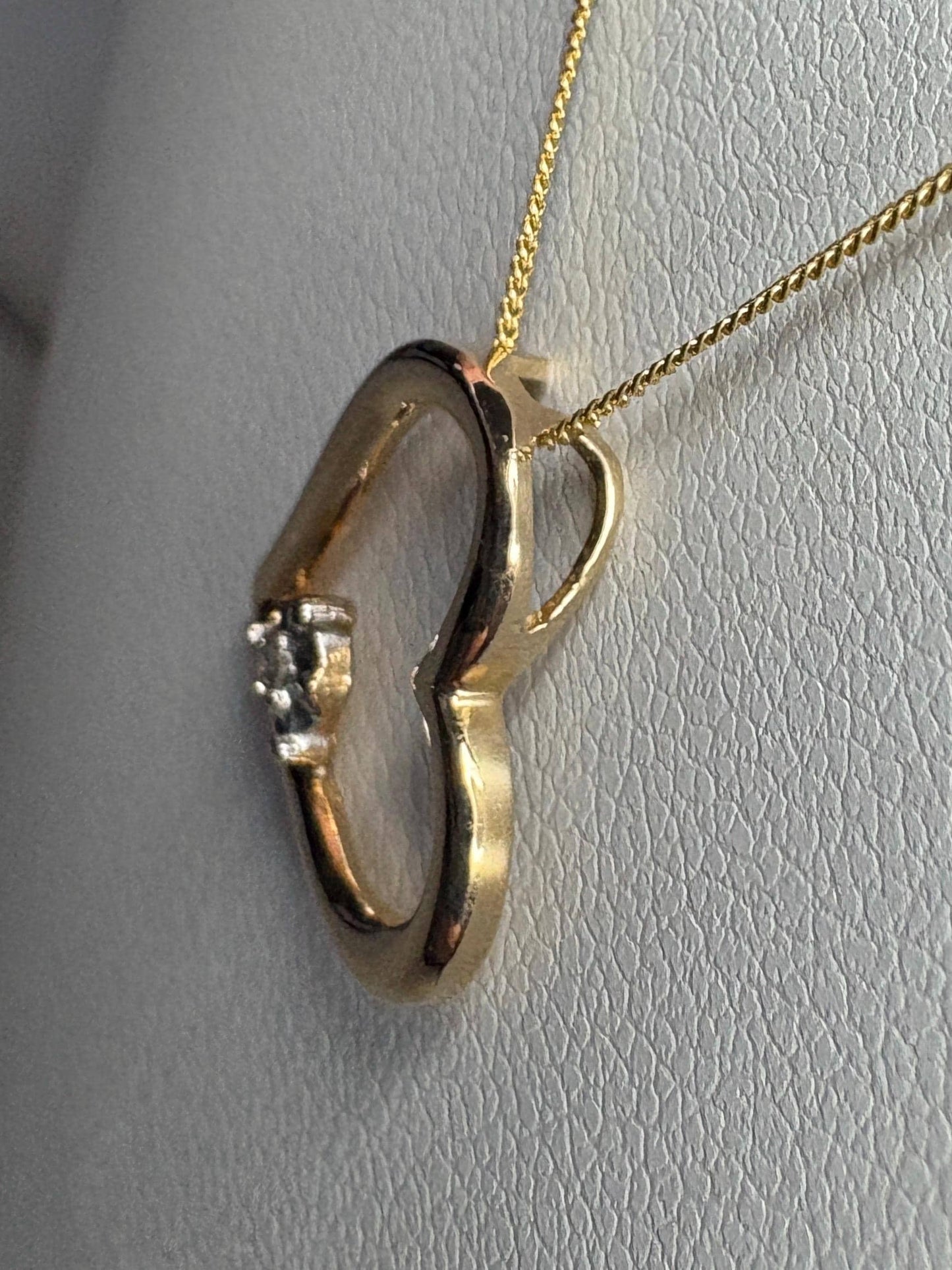 A 10k gold heart pendant with a small diamond on an 18-inch 9k gold chain.