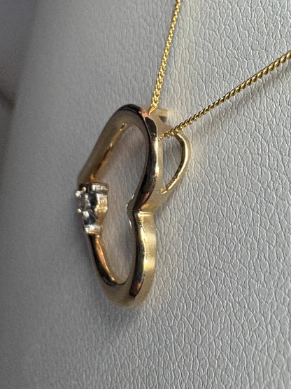 A 10k gold heart pendant with a small diamond on an 18-inch 9k gold chain.