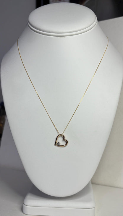 A 10k gold heart pendant with a diamond chip on an 18-inch 9k gold chain.