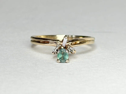 Oval alexandrite and baguette diamond ring in 14k gold.