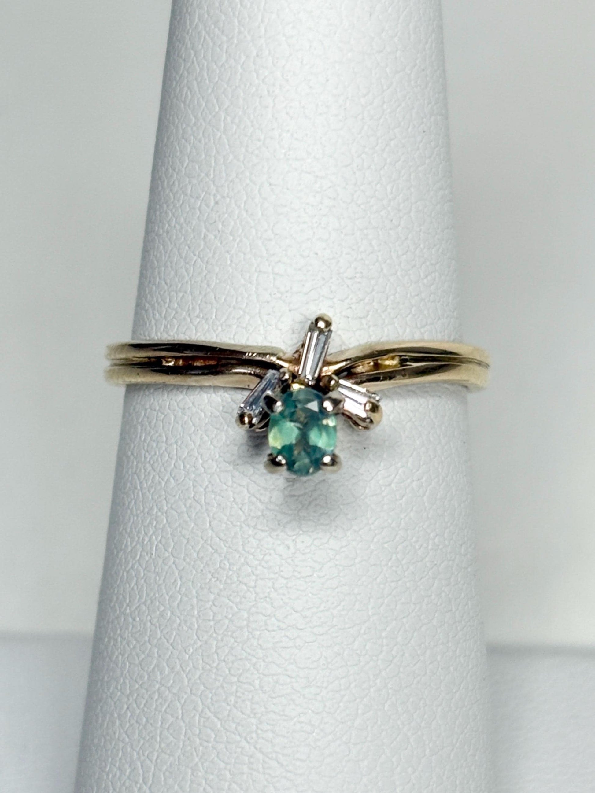 14k gold ring with oval alexandrite and baguette diamonds.