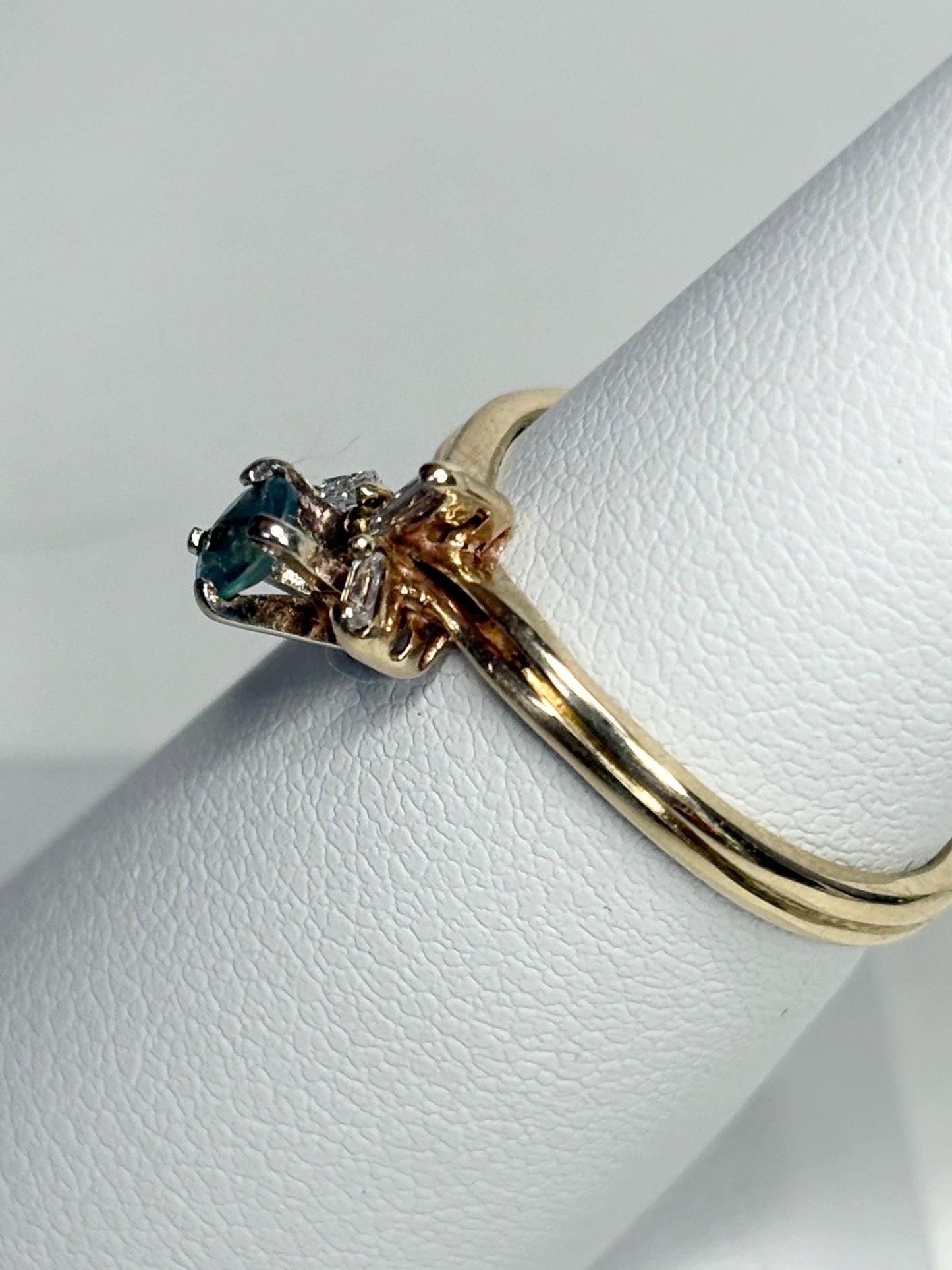 14k gold ring with oval alexandrite and baguette diamonds.