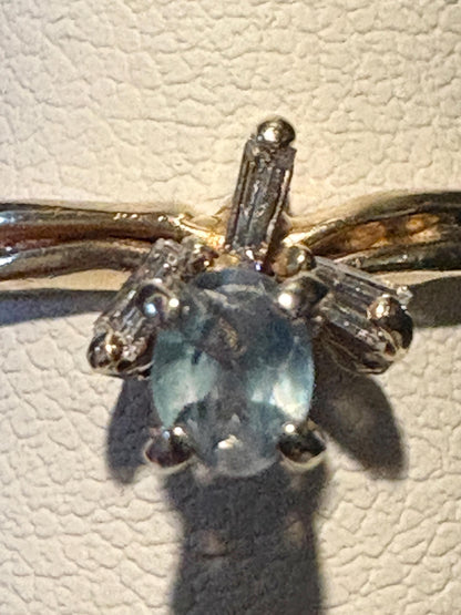 14k gold ring with oval alexandrite and baguette diamonds.