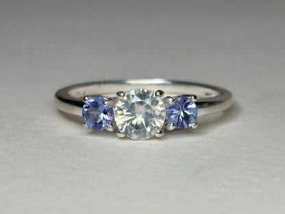 Sterling silver ring with a central off-white zircon and two tanzanite stones.