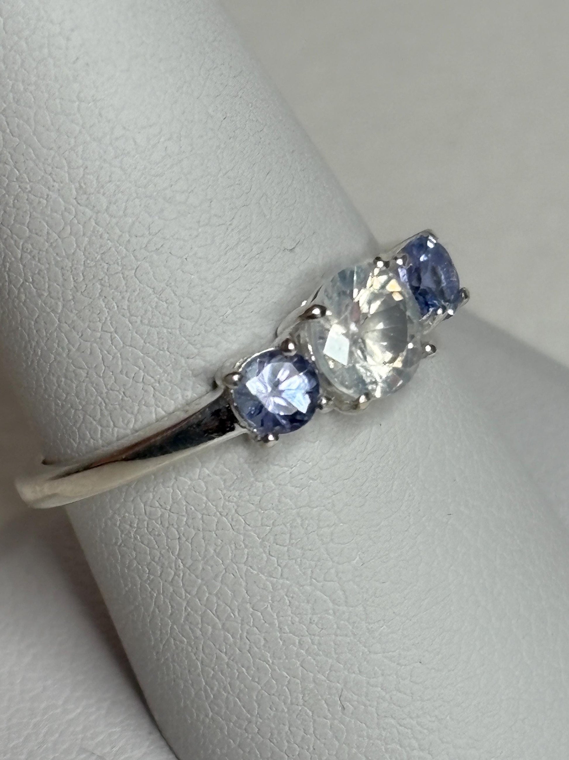 Sterling silver ring with a milky zircon and two tanzanite stones.