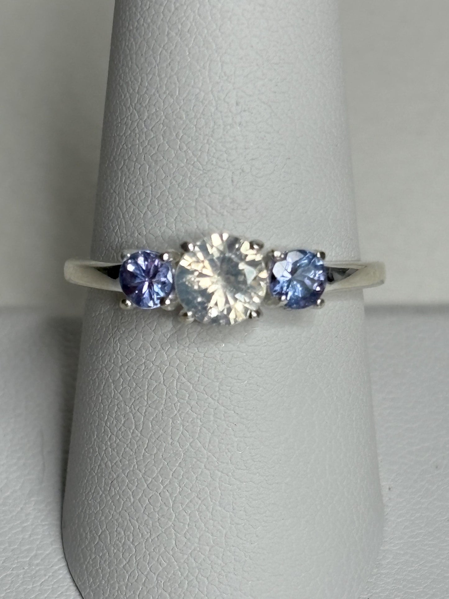 Sterling silver ring with a central off-white zircon and two tanzanite stones.