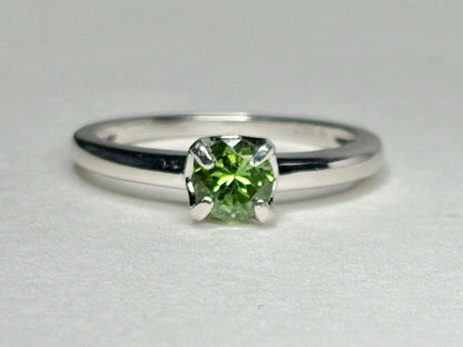 Sterling silver ring with a round, green tourmaline gemstone.