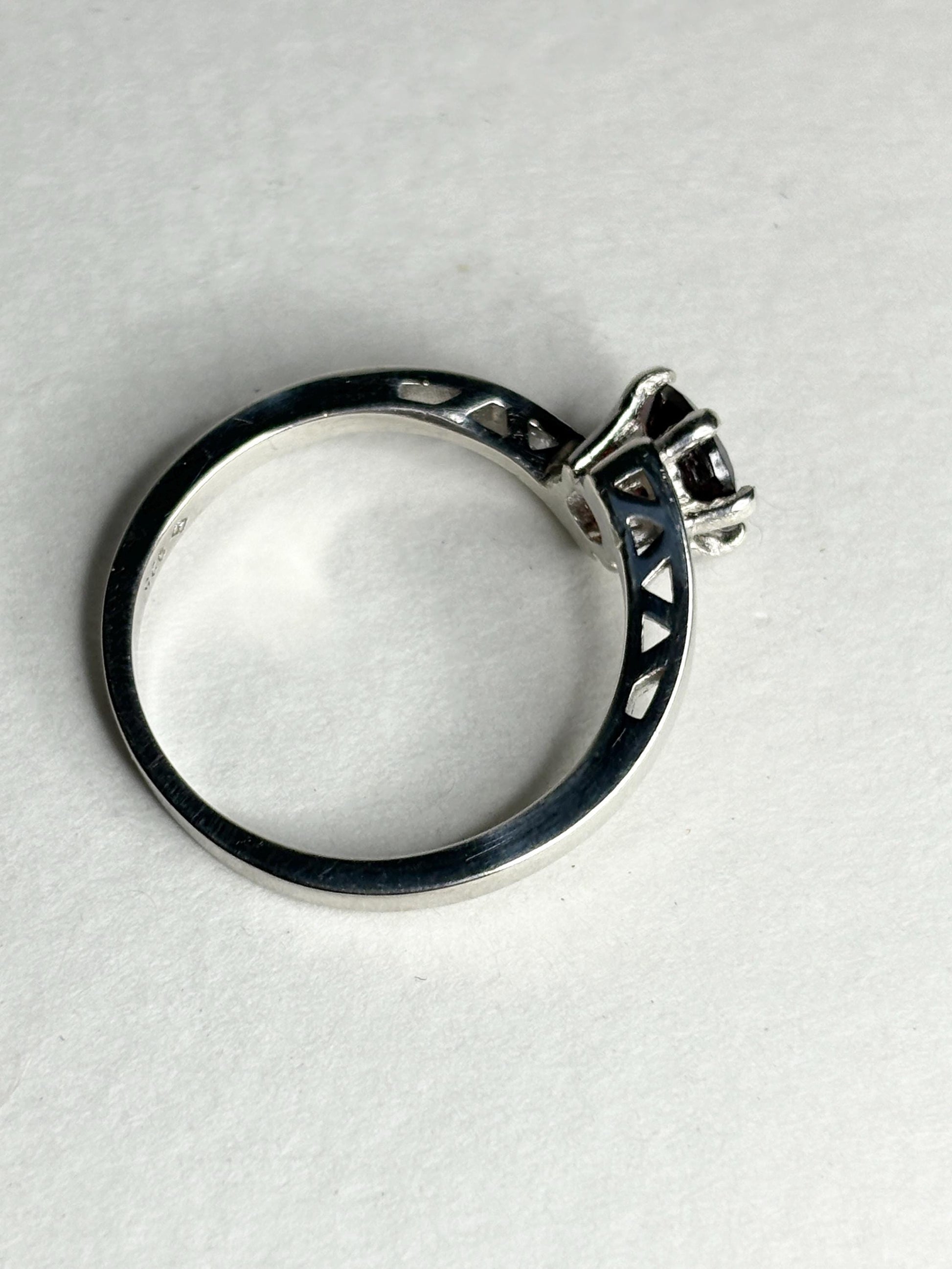 Sterling silver bypass ring with a round pyrope garnet.