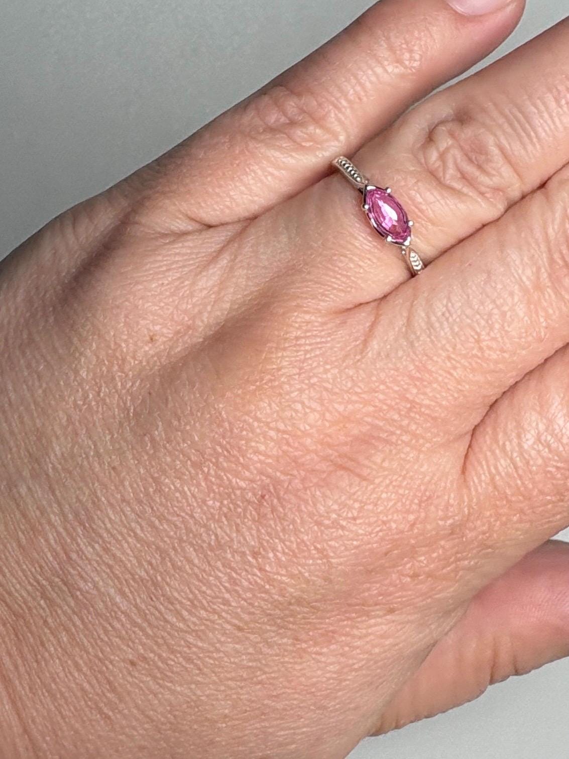 Sterling silver ring with a marquise-cut pink sapphire set east-west.