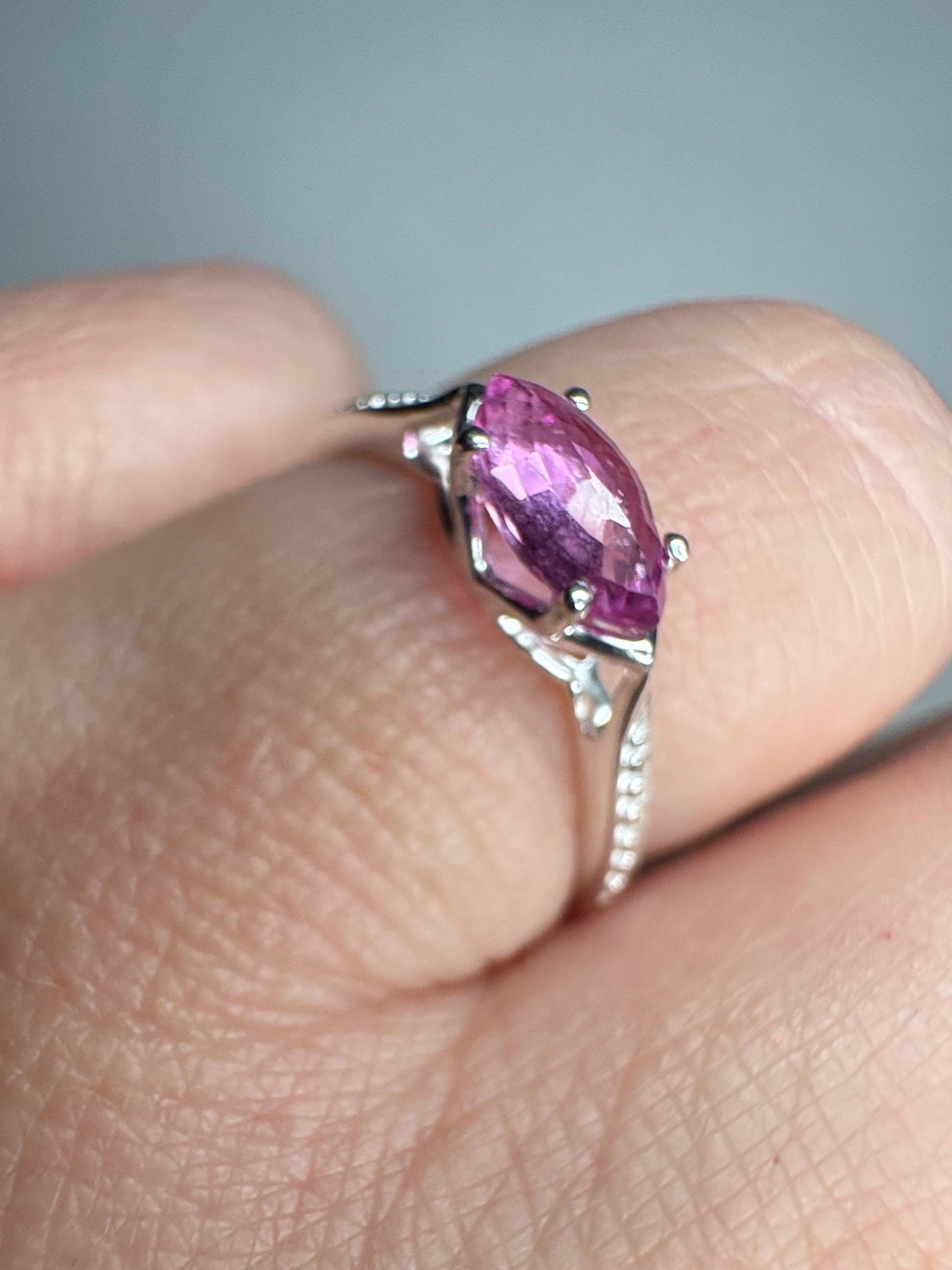 Sterling silver ring with a rose-cut marquise pink sapphire and beaded band.