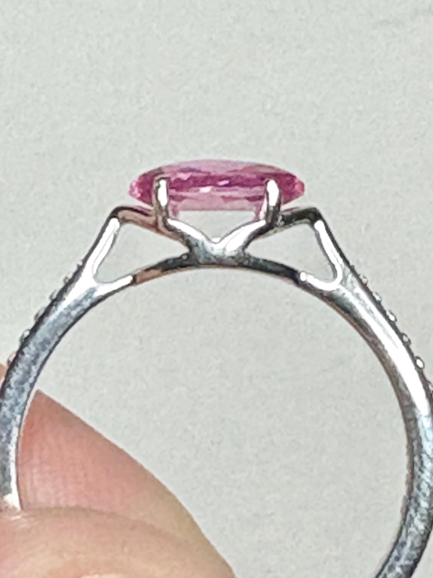 Sterling silver ring with a reverse-set marquise pink sapphire and beaded band.