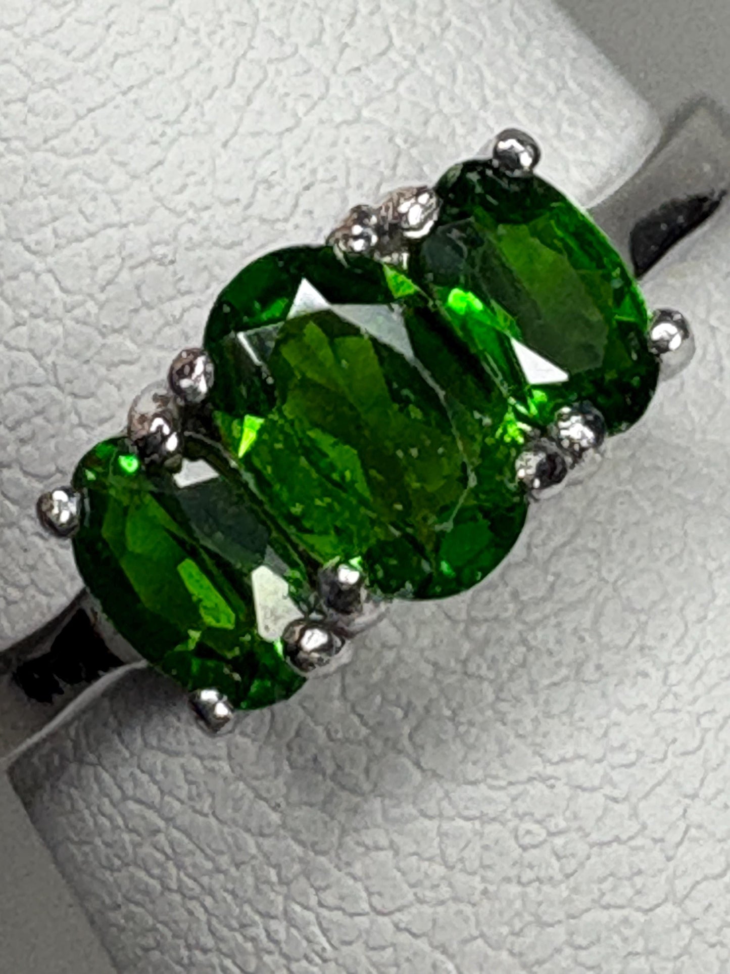 Sterling silver ring with three oval chrome diopside stones.