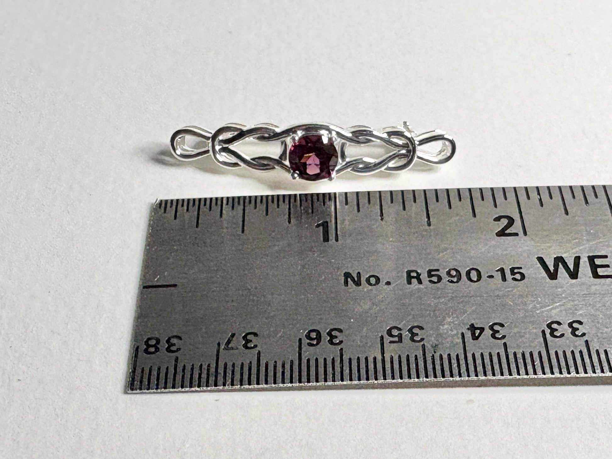 Rhodolite garnet Celtic knot brooch in sterling silver.