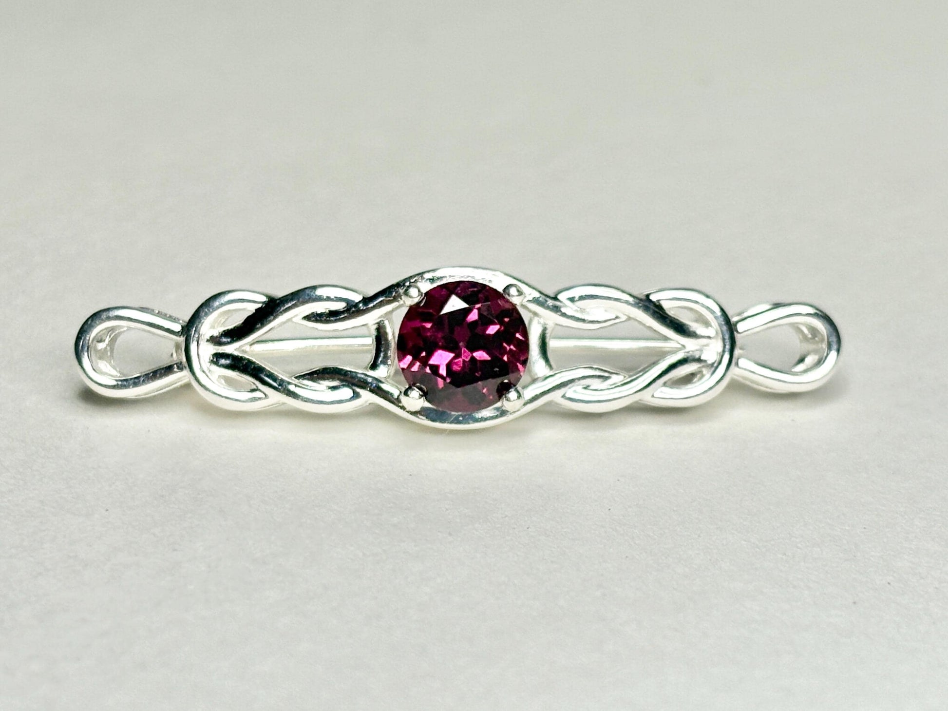 Rhodolite garnet Celtic knot bar brooch in solid sterling silver.