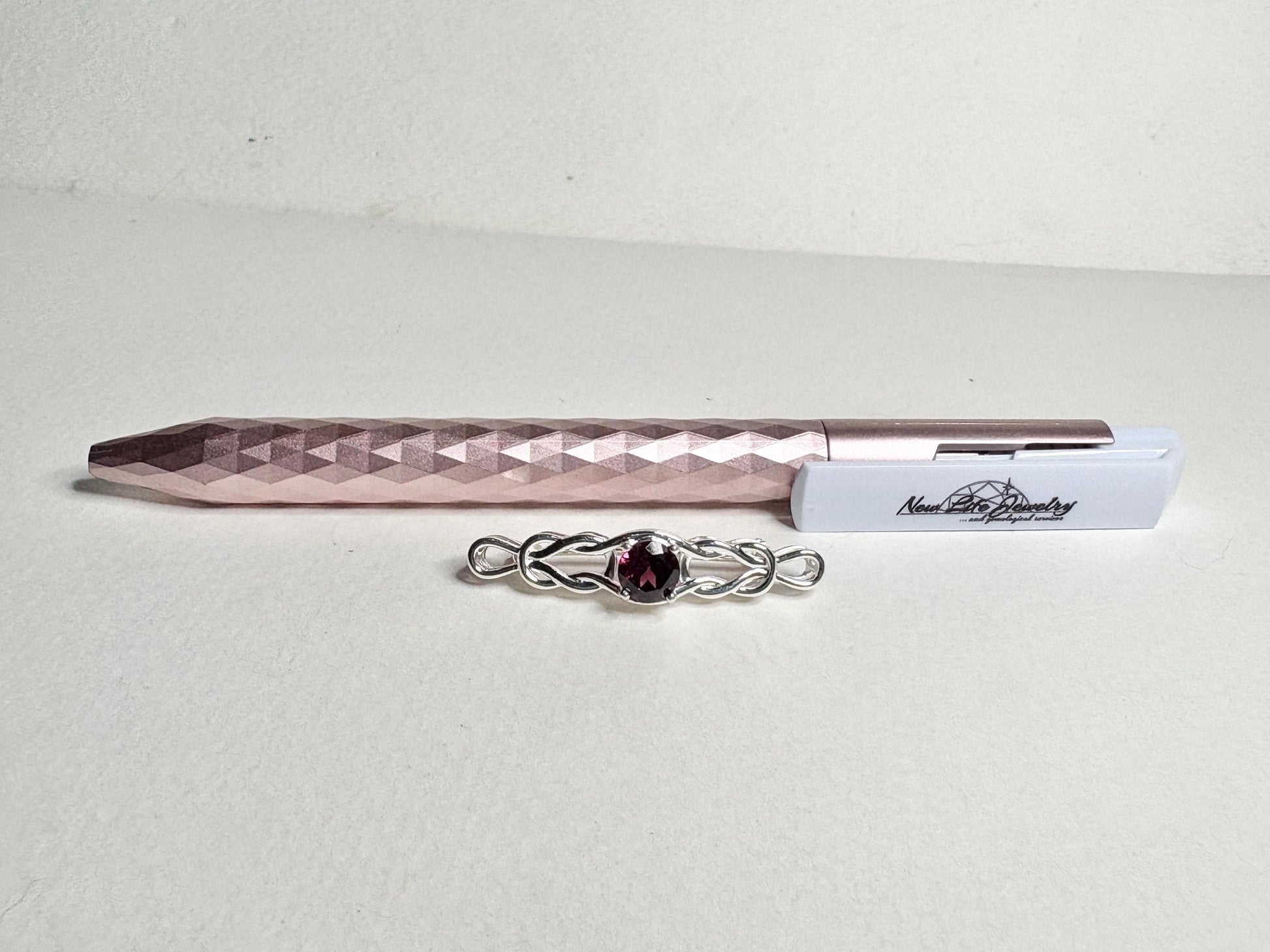 Rhodolite garnet Celtic knot style bar brooch in solid sterling silver.