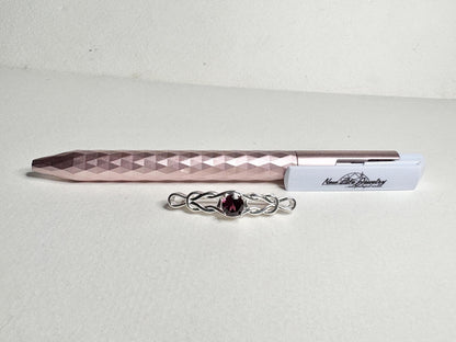 Rhodolite garnet Celtic knot style bar brooch in solid sterling silver.