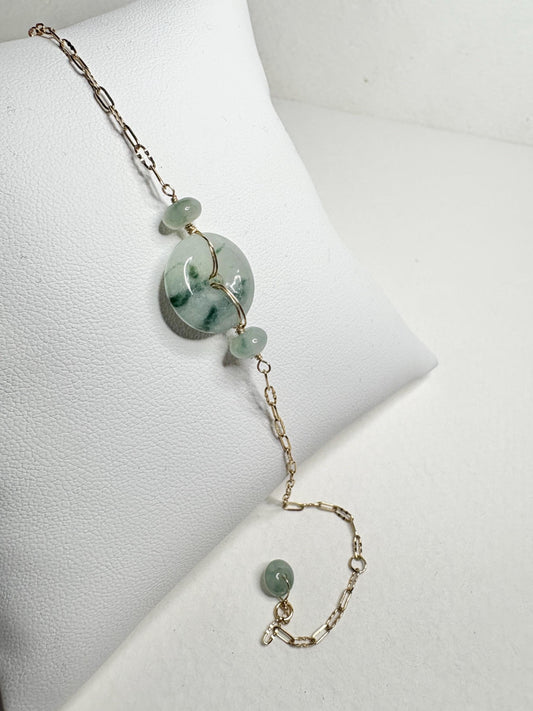 14k gold bracelet with a Type A Burmese jadeite Pi donut and moss in snow inclusions.