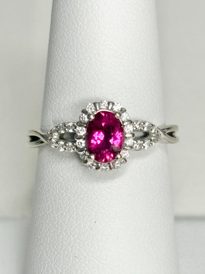 Oval rubellite tourmaline and diamond halo ring in 10k white gold.