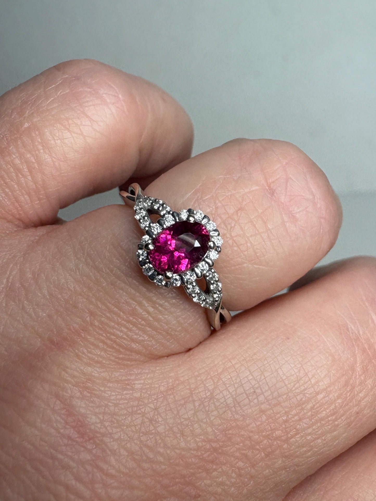 Rubellite tourmaline and diamond halo ring in 10k white gold.