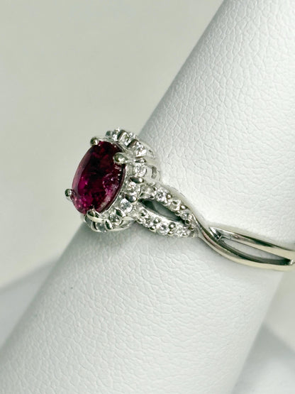 Oval rubellite tourmaline and diamond halo ring in 10k white gold.