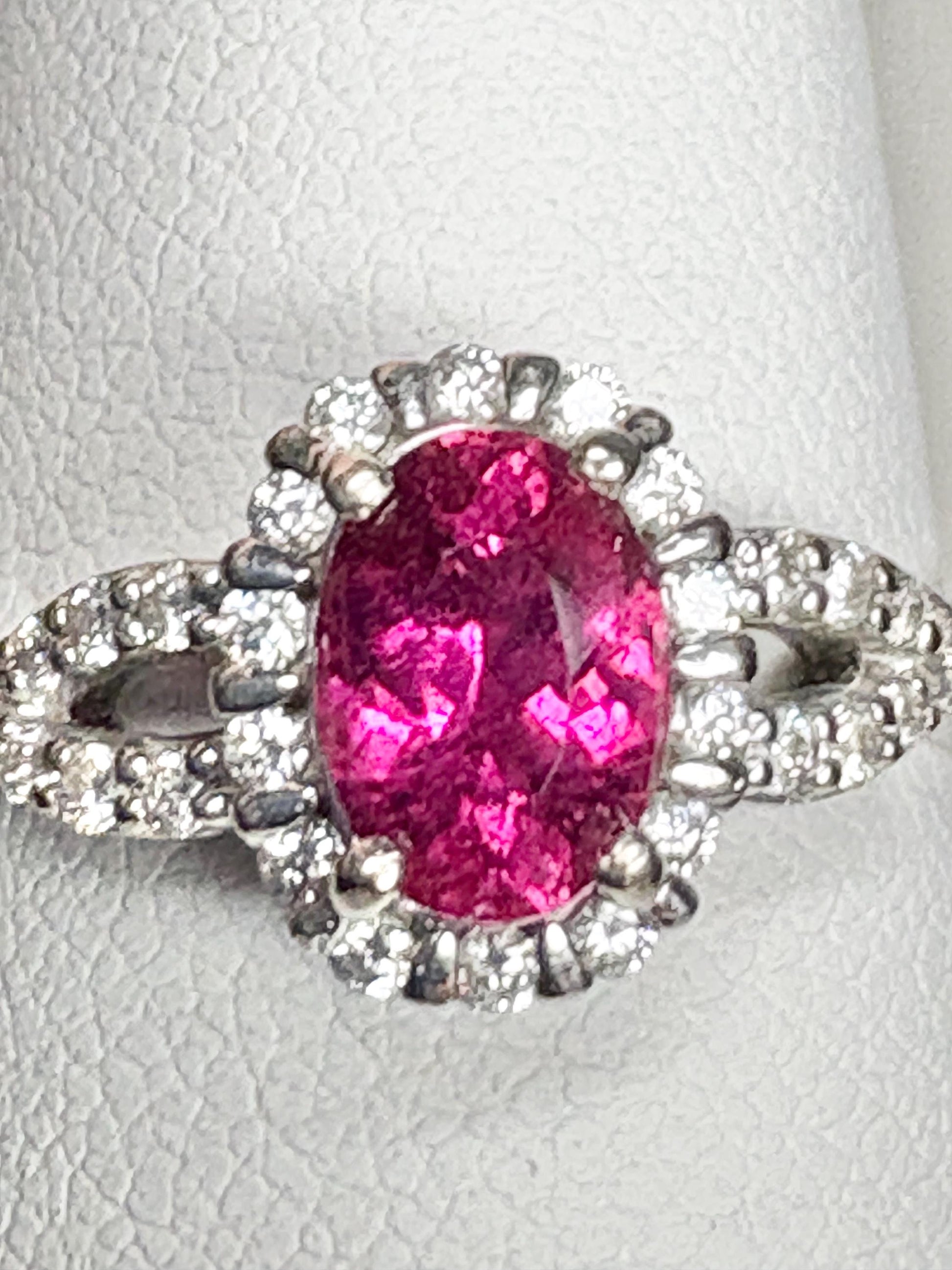 Rubellite tourmaline and diamond halo ring in 10k white gold.