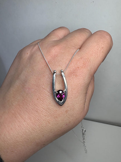 Sterling silver pendant necklace with a pear-shaped grape rhodolite garnet.