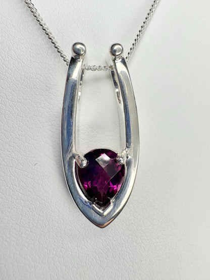 Sterling silver pendant necklace with a pear-shaped grape rhodolite garnet.