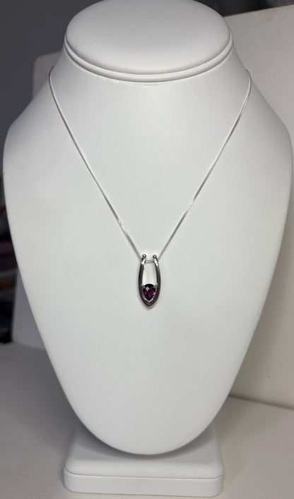 Sterling silver pendant necklace with a pear-shaped grape rhodolite garnet.