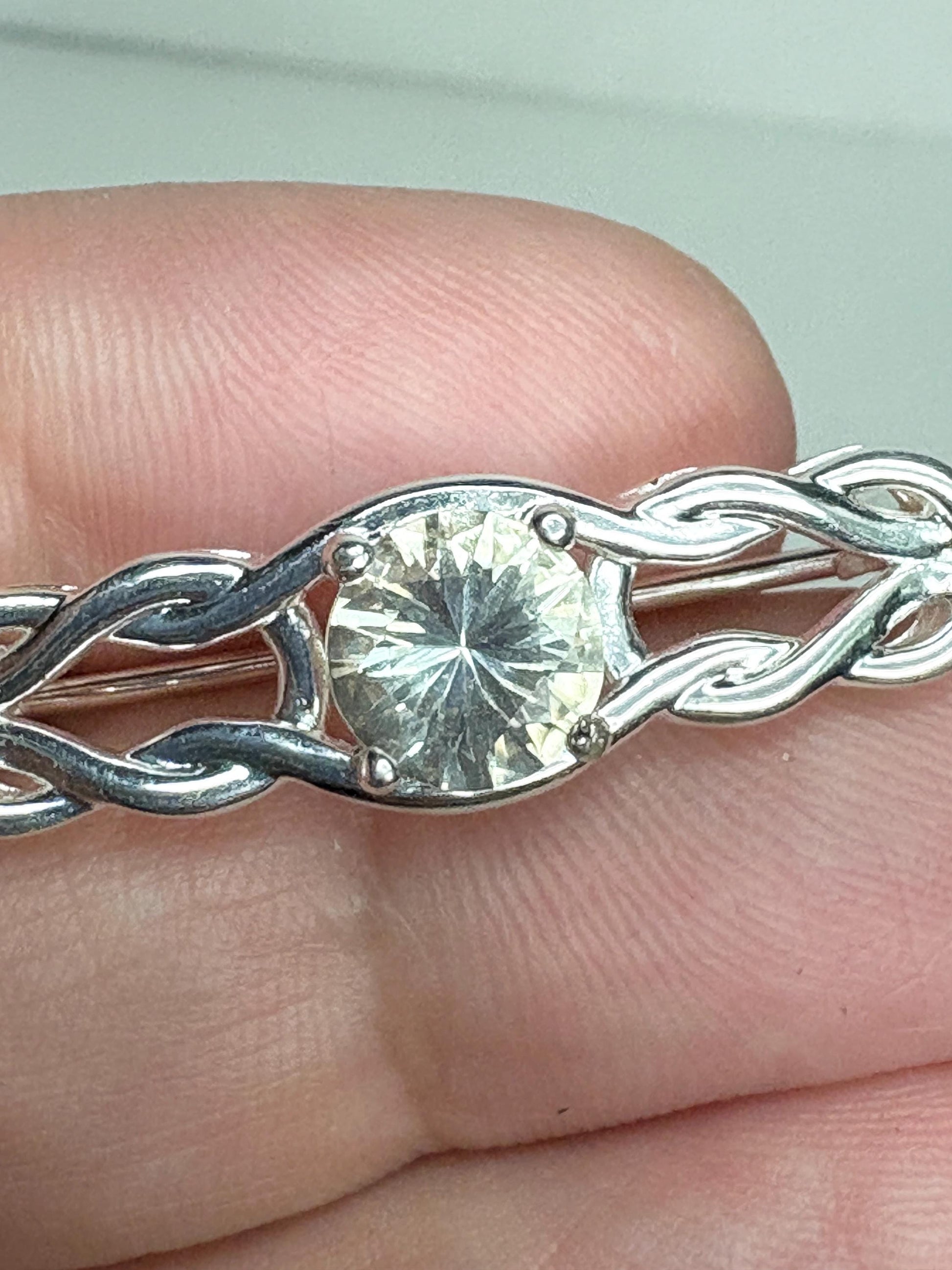 Yellow Oregon sunstone brooch with Celtic knot design in sterling silver.