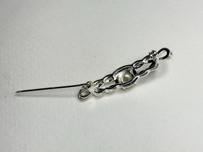 Sterling silver brooch with a Celtic knot design and a yellow Oregon sunstone.