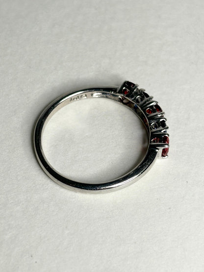 Sterling silver band ring with red and blue sapphires.