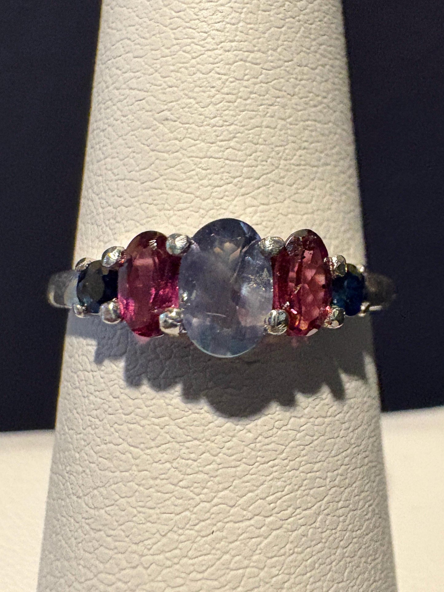 Sterling silver ring with oval alexandrite, rhodolite garnets, and blue sapphires.