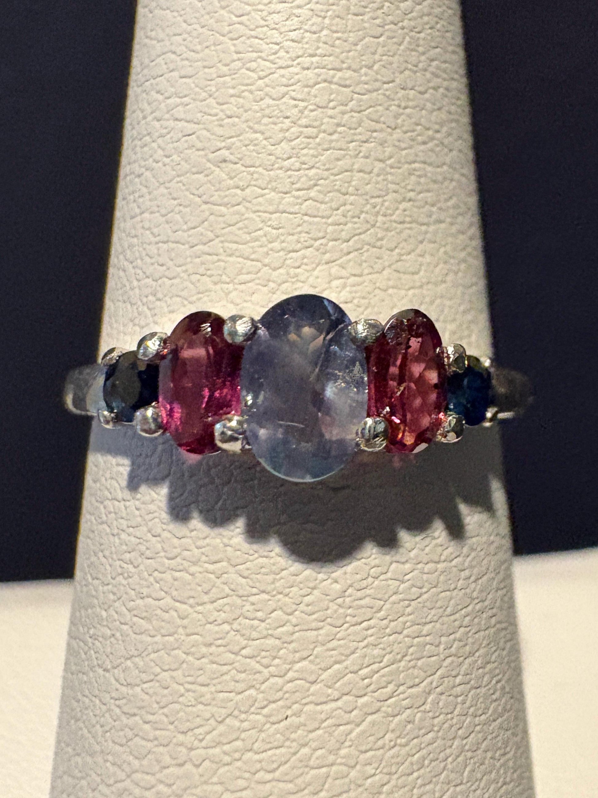 Sterling silver ring with oval alexandrite, rhodolite garnets, and blue sapphires.