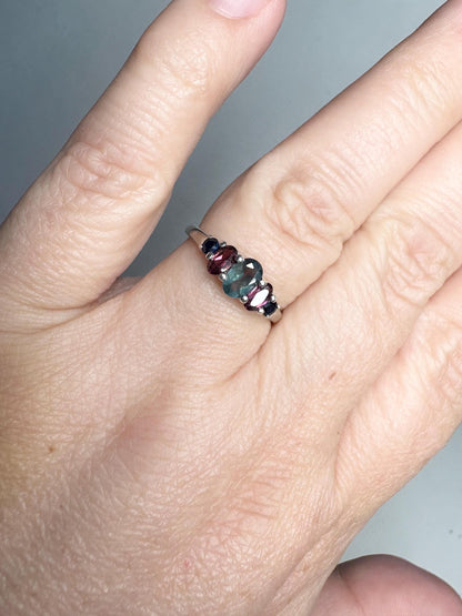 Sterling silver ring with oval alexandrite, rhodolite garnets, and blue sapphires.
