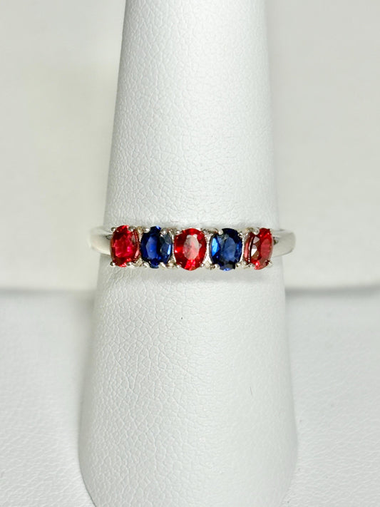 Sterling silver band ring with oval red and blue sapphires.