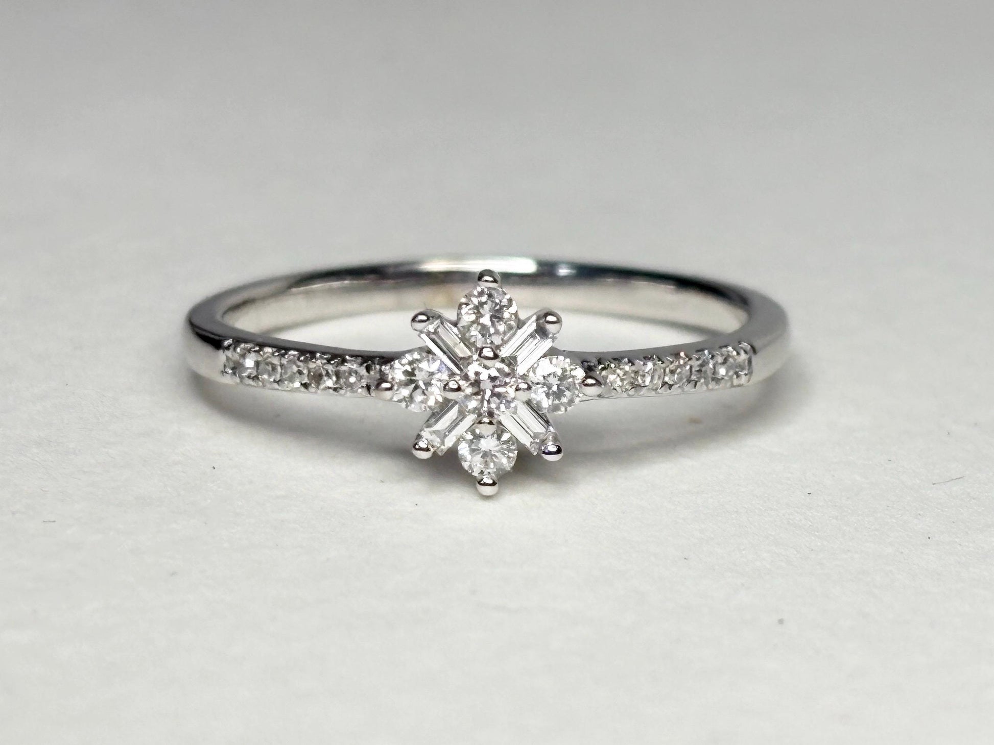 Baguette and round diamond starburst ring in 10k white gold.