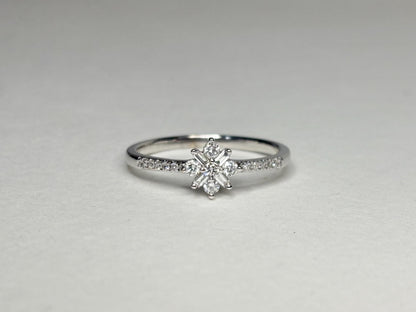 A white gold ring with a starburst design of baguette and round diamonds.