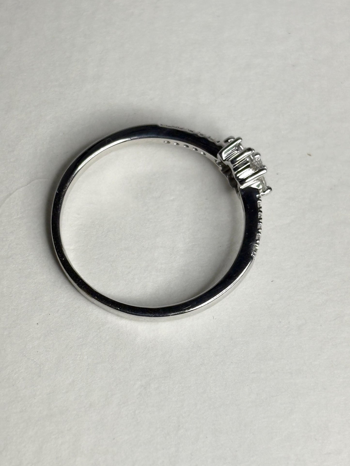 Ring with baguette and round diamonds in a starburst design on white gold.