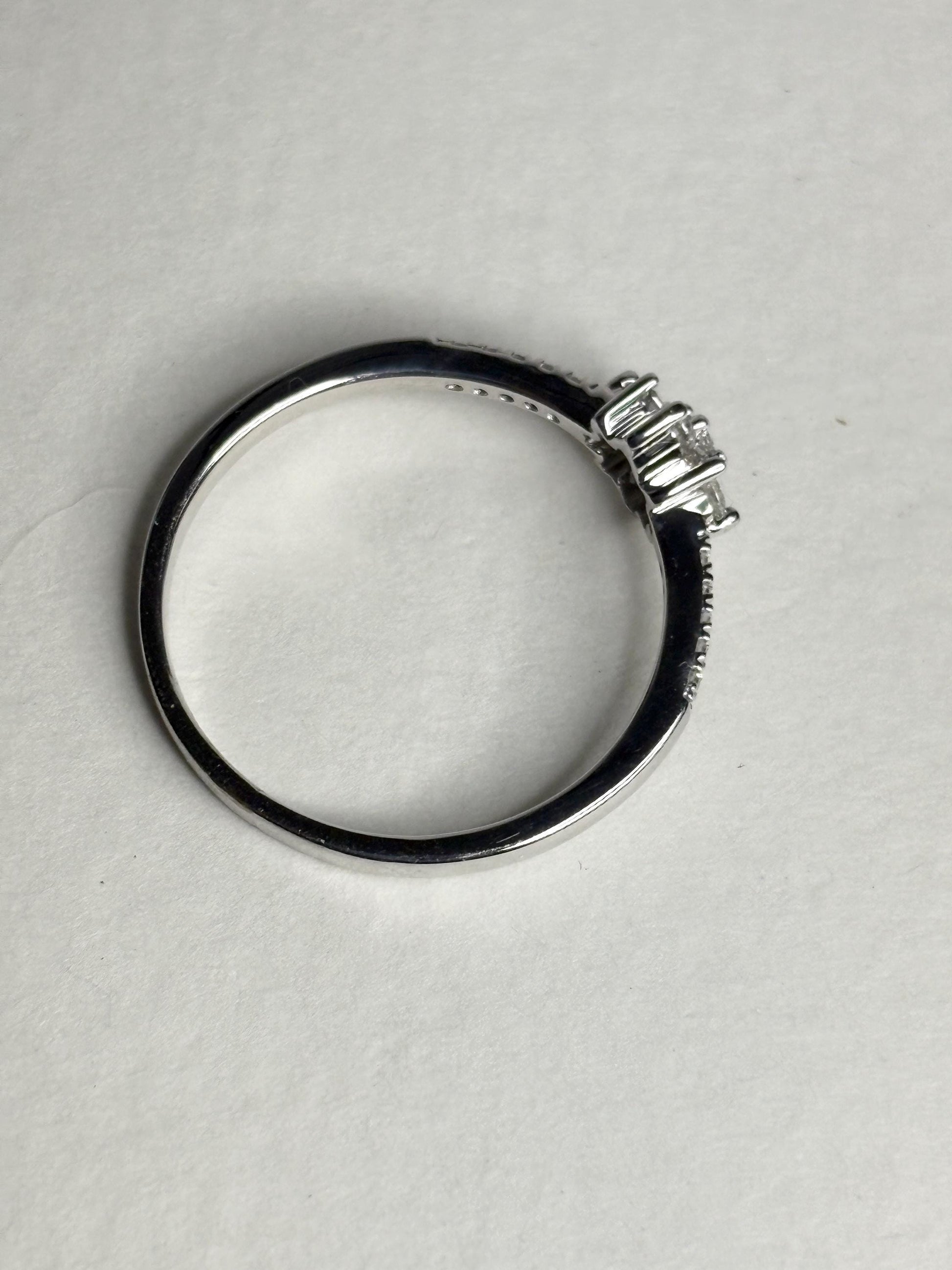 Ring with baguette and round diamonds in a starburst design on white gold.