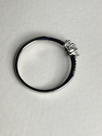 Ring with baguette and round diamonds in a starburst design on white gold.