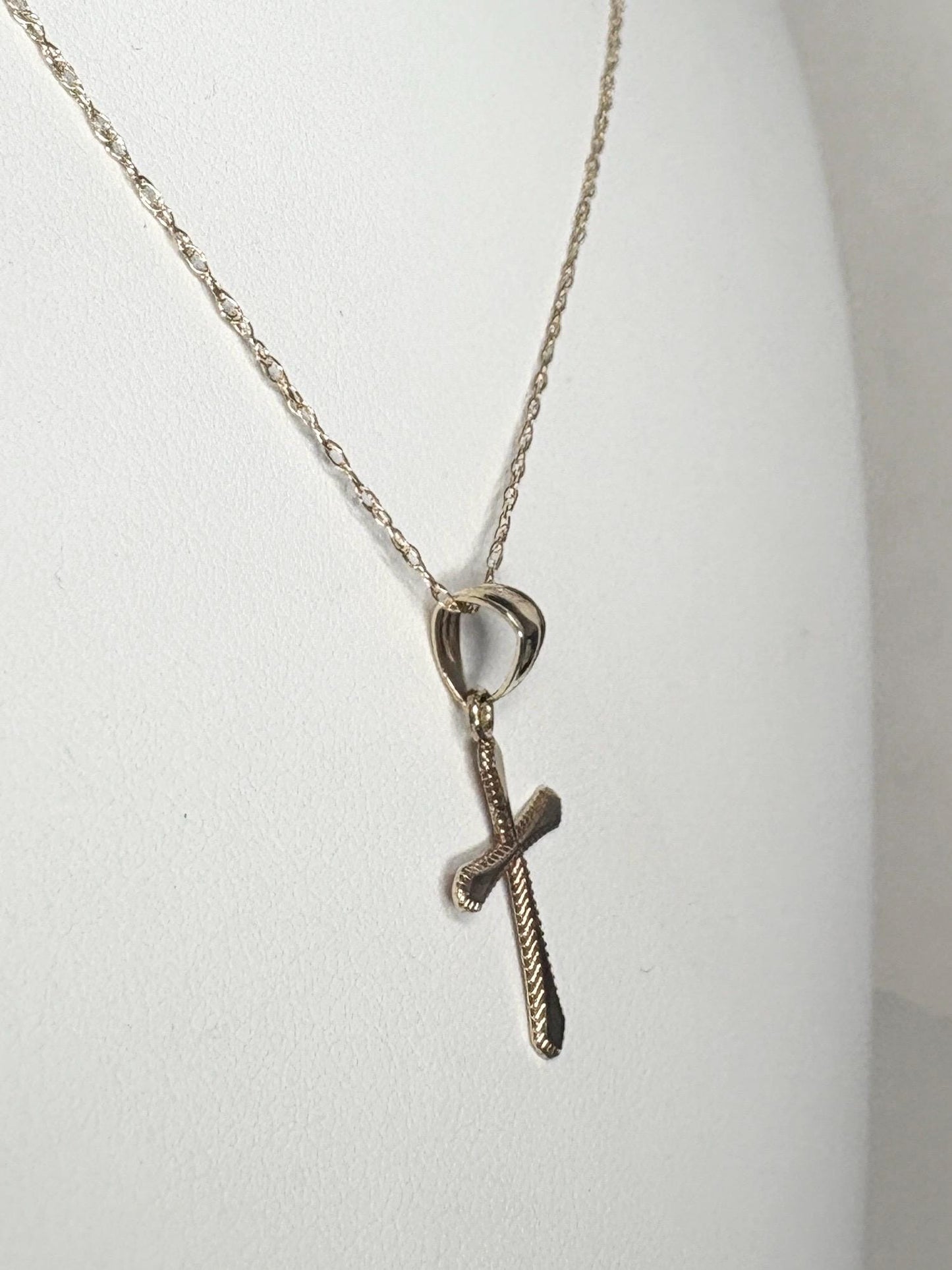 Solid 10k gold cross pendant on a 19-inch rope chain.
