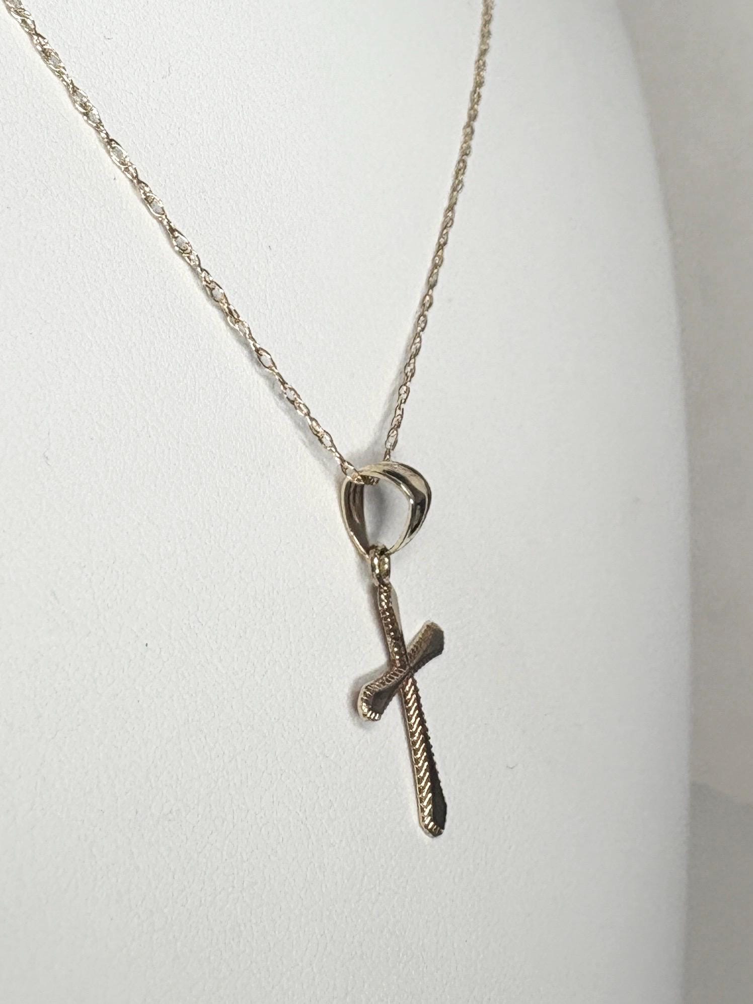 Solid 10k gold cross pendant on a 19-inch rope chain.