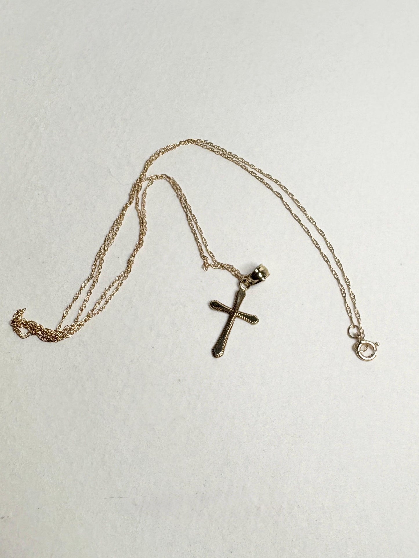 Solid 10k gold cross pendant necklace on a 19-inch rope chain.