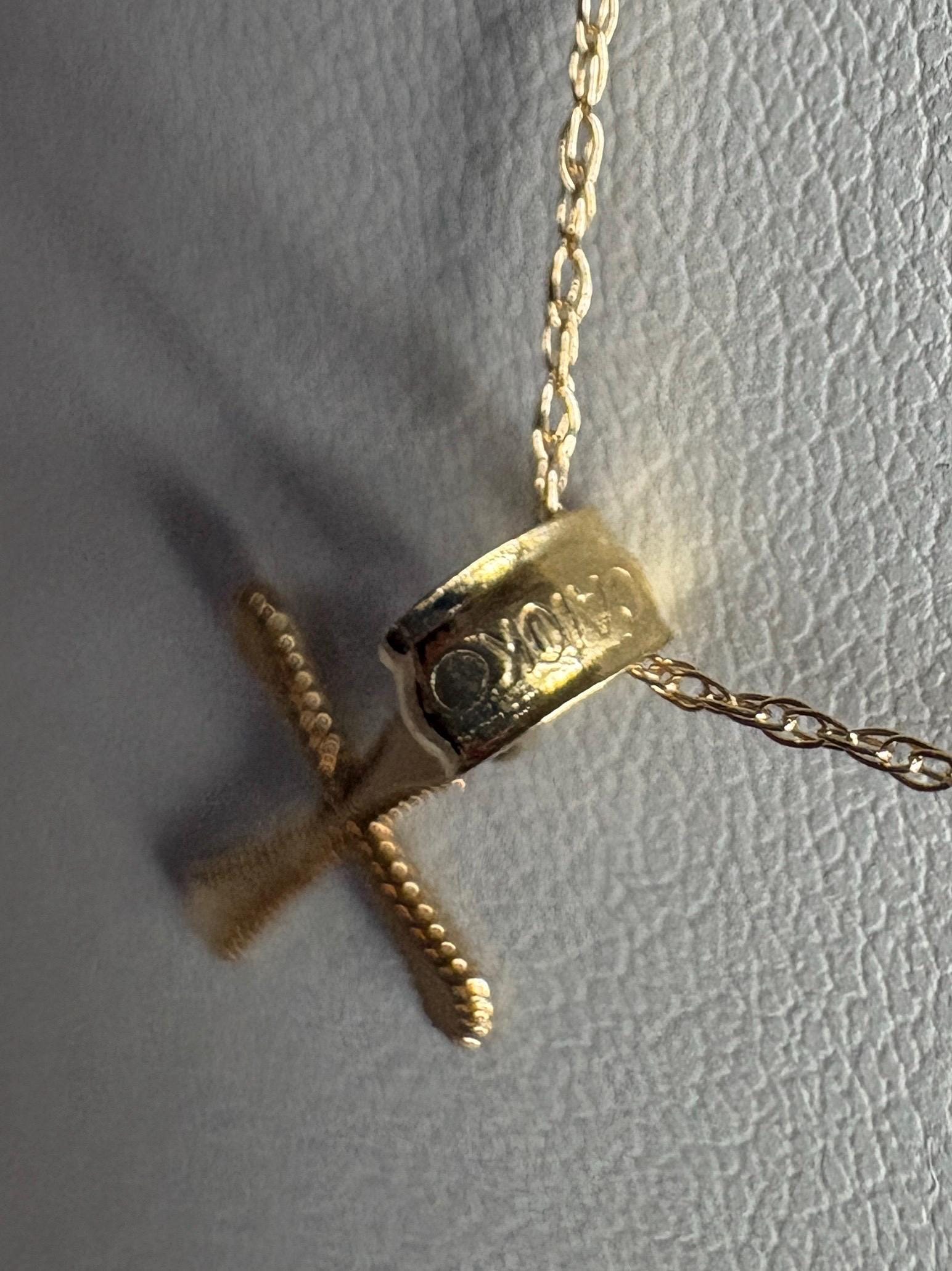 Solid 10k gold cross pendant necklace with a fine rope chain.