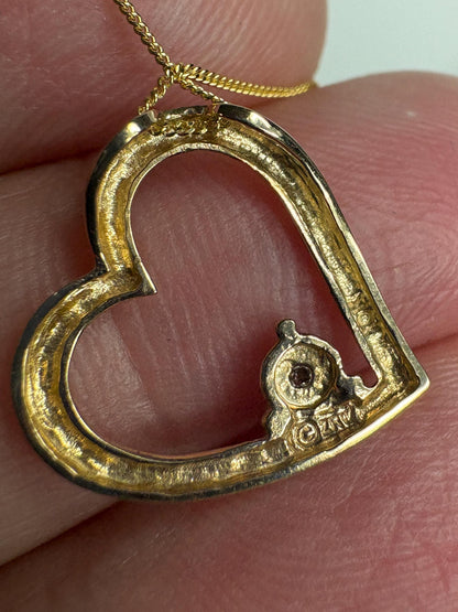 A 10k gold heart pendant with a small diamond on an 18-inch 9k gold chain.