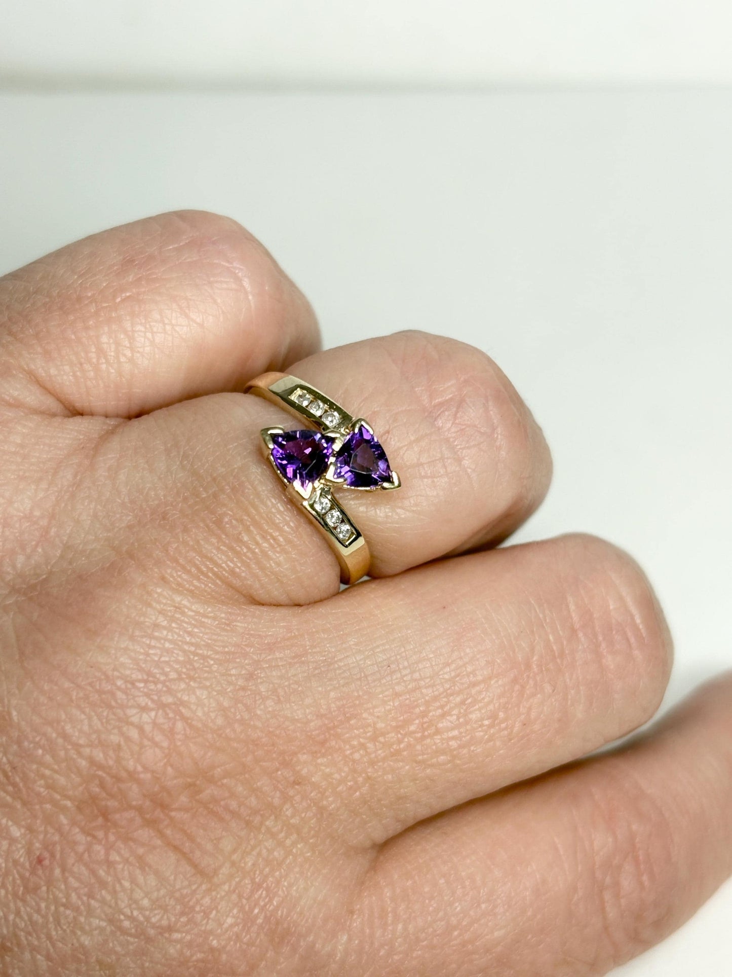 Amethyst trillion bypass ring with diamonds in 10k gold.