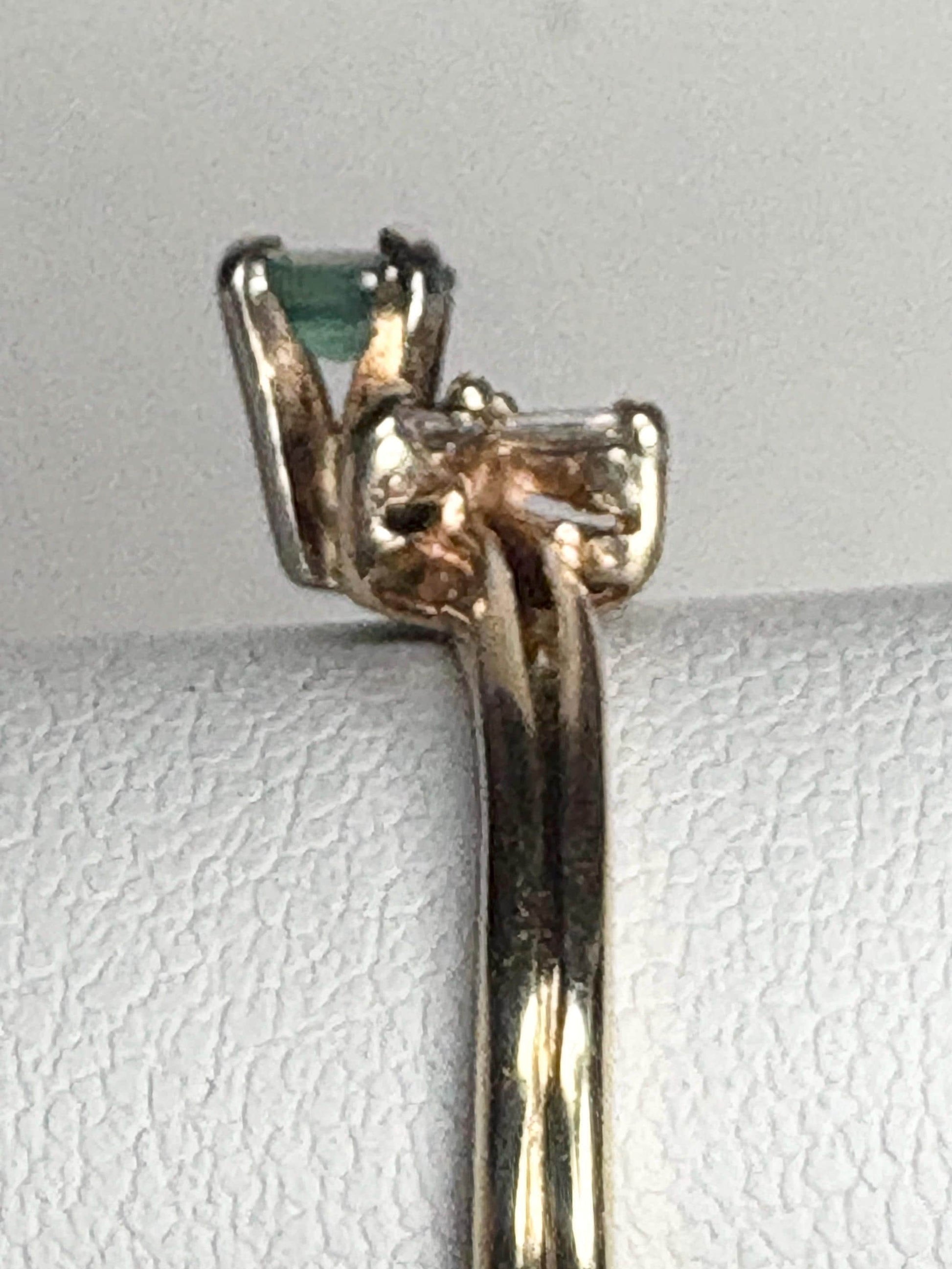 14k gold ring with an oval alexandrite and baguette diamonds.