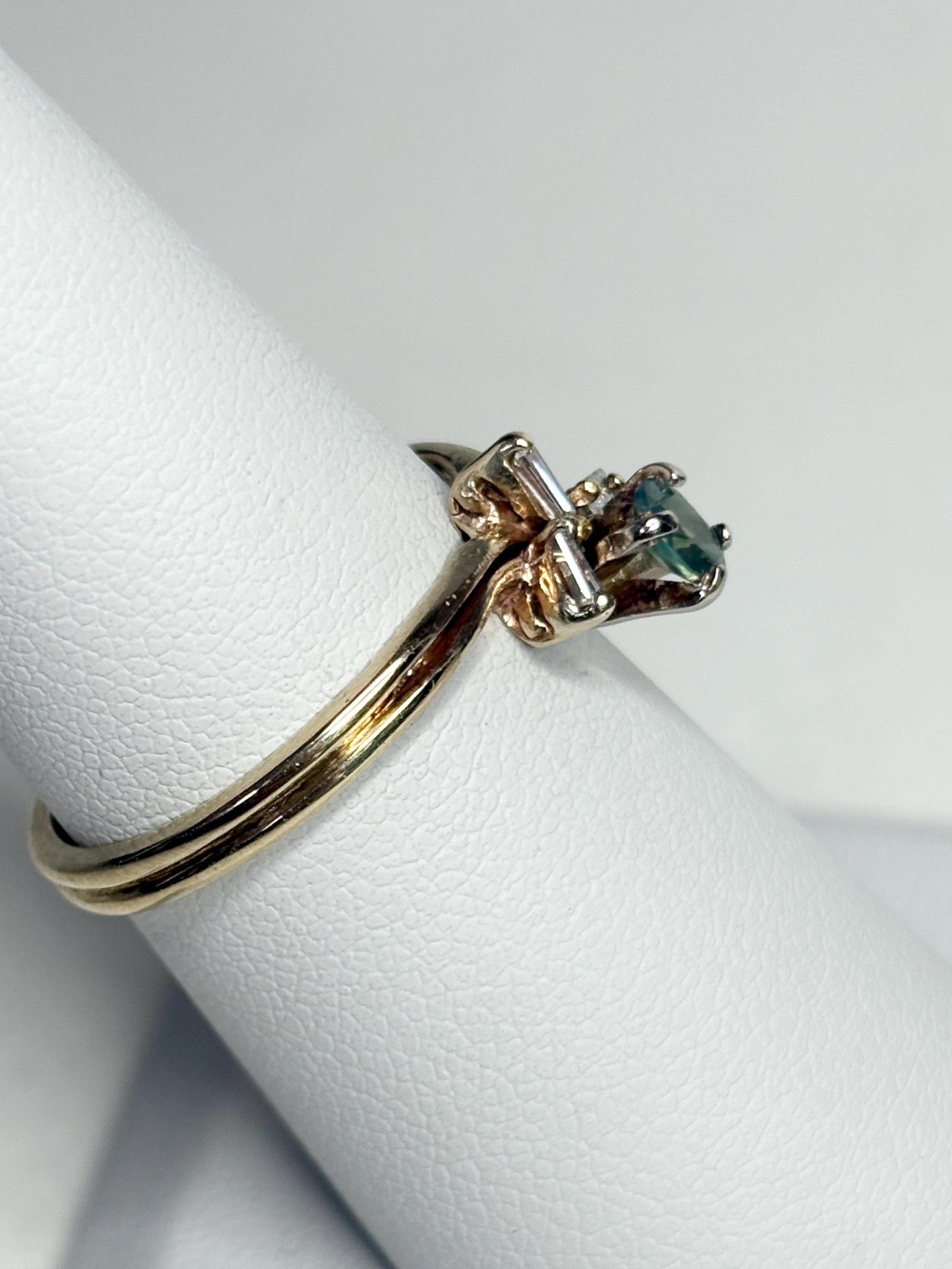14k gold ring with oval alexandrite and baguette diamonds.