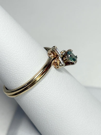 14k gold ring with oval alexandrite and baguette diamonds.